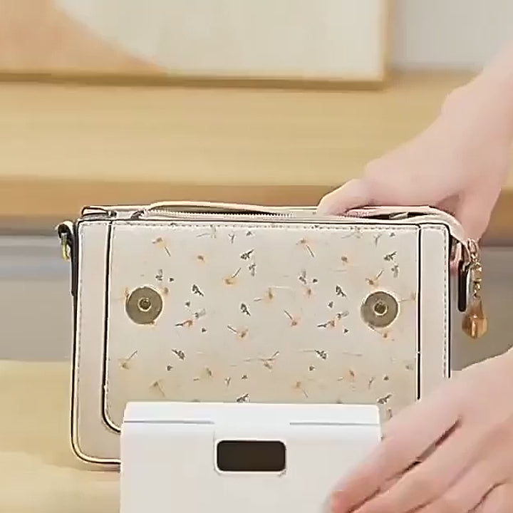 Putting the small sealer into a handbag