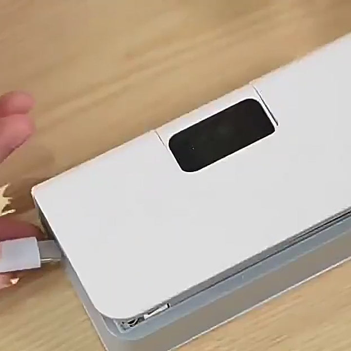 Plugging a USB-C cable into the sealer to charge it